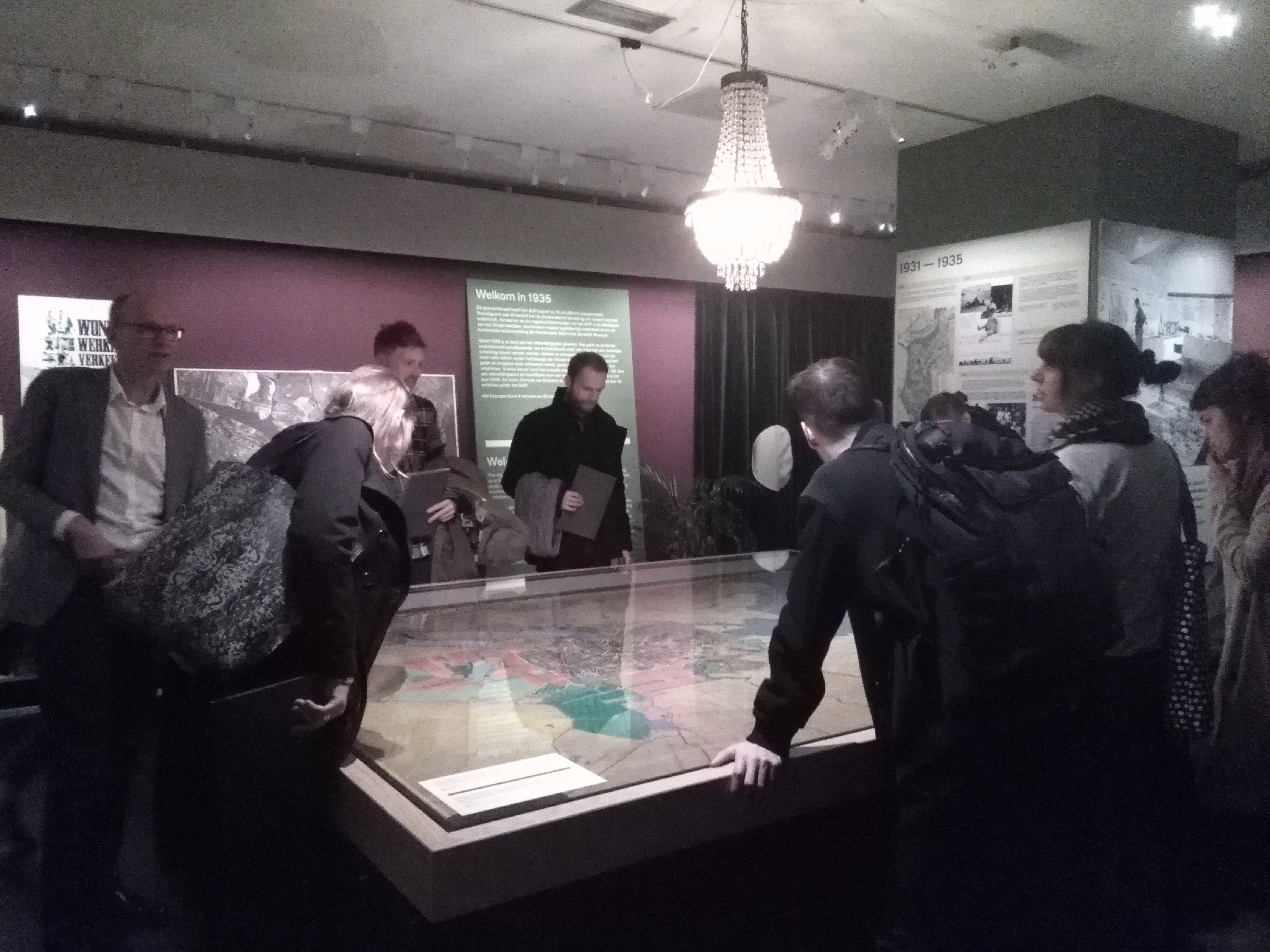 Het team kijkt naar de kaart van Van Eesteren tijdens de rondleiding door de tentoonstelling Een Betere Stad